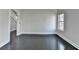 Empty bedroom with hardwood floors, natural light, and a staircase in the background at 73 Atlanta Sw Ave, Atlanta, GA 30315