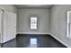 An empty bedroom showcasing hardwood floors, white walls, natural light, and simple elegance, ready for personalization at 73 Atlanta Sw Ave, Atlanta, GA 30315