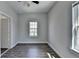 Cozy bedroom boasts neutral decor, hardwood flooring, and natural light with entry door at 73 Atlanta Sw Ave, Atlanta, GA 30315