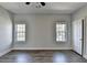 Bright bedroom with hardwood floors, neutral paint, large windows, and a ceiling fan at 73 Atlanta Sw Ave, Atlanta, GA 30315