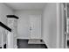 Inviting foyer with dark wood floors, white walls, a classic staircase, and a glimpse of natural light, exuding simple elegance at 73 Atlanta Sw Ave, Atlanta, GA 30315