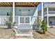 Close-up of a charming front porch with a gated entrance, small trees, and steps leading to the home's front door at 73 Atlanta Sw Ave, Atlanta, GA 30315