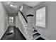 Bright hallway with dark hardwood floors, a classic white staircase with black accents, and access to other rooms at 73 Atlanta Sw Ave, Atlanta, GA 30315