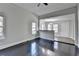 Open-concept living room with large windows, hardwood floors, and view to dining area at 73 Atlanta Sw Ave, Atlanta, GA 30315