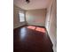 Well-lit bedroom featuring hardwood floors and a view to the outdoors at 7563 Avalon Blvd # 305, Fairburn, GA 30213