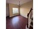 Bright dining area with hardwood floors, natural light, and staircase access at 7563 Avalon Blvd # 305, Fairburn, GA 30213