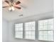 Sunlit bedroom featuring a ceiling fan and three windows allowing ample natural light at 1526 Viero Dr, Lawrenceville, GA 30044