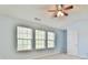 Bright bedroom with a ceiling fan and three windows that allow ample natural light at 1526 Viero Dr, Lawrenceville, GA 30044