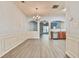 Open-concept living and dining area with gray wood-look floors, a chandelier, and ample natural light at 1526 Viero Dr, Lawrenceville, GA 30044