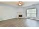 Spacious living room featuring a cozy fireplace and abundant natural light from a large window at 1526 Viero Dr, Lawrenceville, GA 30044