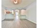 Light-filled living room with an arched opening leading to the kitchen, offering a seamless flow for modern living at 1526 Viero Dr, Lawrenceville, GA 30044