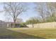 Spacious backyard featuring a wooden fence and screened-in porch for outdoor relaxation and entertaining at 10375 Plantation Bridge Dr, Johns Creek, GA 30022