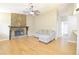 Comfortable living room with stone fireplace, ceiling fan, and hardwood flooring at 10375 Plantation Bridge Dr, Johns Creek, GA 30022