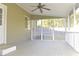 View of screened porch with tiled floors and ceiling fan with access to back yard at 10375 Plantation Bridge Dr, Johns Creek, GA 30022