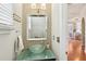 Stylish powder room with a glass vessel sink, mosaic tile accent wall, and modern fixtures at 1056 Shady Valley Ne Pl, Brookhaven, GA 30324