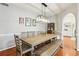 Dining room features a large table with bench seating beneath a modern light fixture, ideal for gatherings at 1056 Shady Valley Ne Pl, Brookhaven, GA 30324