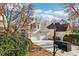 View of a two-story house with a two-car garage, set against a backdrop of mature trees and blue skies at 1056 Shady Valley Ne Pl, Brookhaven, GA 30324