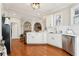 Well-lit kitchen featuring white cabinets, stainless steel appliances, hardwood floors, and an open layout at 1056 Shady Valley Ne Pl, Brookhaven, GA 30324