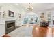 Cozy living room featuring hardwood floors, a fireplace, and an open archway at 1056 Shady Valley Ne Pl, Brookhaven, GA 30324