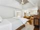 View of the main bedroom area with a fireplace, hardwood floors, ceiling fan, and lounge seating at 1056 Shady Valley Ne Pl, Brookhaven, GA 30324