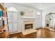 Bright sitting room features hardwood floors, plantation shutters, fireplace, and a vintage bookcase at 1056 Shady Valley Ne Pl, Brookhaven, GA 30324