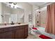 A full bathroom featuring a vanity with granite countertops and a shower-tub combo with striped curtains at 120 Chastain Nw Rd # 1204, Kennesaw, GA 30144