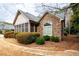 Charming home exterior featuring stone accents, manicured landscaping, and a screened porch at 120 Chastain Nw Rd # 1204, Kennesaw, GA 30144