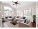 Bright living room with vaulted ceiling, large windows, ceiling fan, and a comfortable seating arrangement at 120 Chastain Nw Rd # 1204, Kennesaw, GA 30144