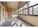 Bright sunroom with tile floors, brick accent wall, and large windows at 120 Chastain Nw Rd # 1204, Kennesaw, GA 30144