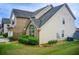 A well-maintained home exterior with vinyl siding, partial brick, and a view of the green backyard at 1909 Sawgrass Dr, Hampton, GA 30228
