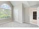 Spacious bedroom with a large window and neutral walls and carpet at 1909 Sawgrass Dr, Hampton, GA 30228