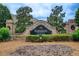 Elegant community sign for Sawgrass Estates amidst lush greenery and stone accents at 1909 Sawgrass Dr, Hampton, GA 30228
