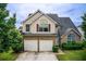 Charming two-story home with a two-car garage and well-maintained lawn and garden at 1909 Sawgrass Dr, Hampton, GA 30228