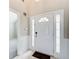 Bright foyer with tiled floor, sidelights, and elegant door detailing at 1909 Sawgrass Dr, Hampton, GA 30228