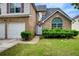 The home's brick facade and manicured front yard enhance curb appeal at 1909 Sawgrass Dr, Hampton, GA 30228