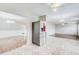 Stainless steel refrigerator in open floor plan with dining and living area at 1909 Sawgrass Dr, Hampton, GA 30228