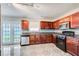 Kitchen with dark wood cabinets, tile backsplash, and stainless steel appliances at 1909 Sawgrass Dr, Hampton, GA 30228