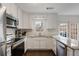 Modern kitchen featuring white cabinets, stainless steel appliances, and granite countertops at 1101 Collier Nw Rd # V3, Atlanta, GA 30318