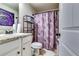 Bathroom featuring granite countertops, stylish purple shower curtain, and white cabinets at 1709 Creel Ln, Atlanta, GA 30349