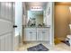 Bathroom with double vanity, granite countertop, decorative lighting, and tile flooring at 1709 Creel Ln, Atlanta, GA 30349