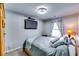 Serene bedroom with a mounted TV, soft carpet, and calming gray bedding set at 1709 Creel Ln, Atlanta, GA 30349
