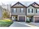 Charming townhome featuring a well-manicured lawn, a garage, and a welcoming front porch at 1709 Creel Ln, Atlanta, GA 30349