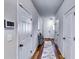 Inviting hallway with light gray walls, wood-look floors, and multiple doors at 1709 Creel Ln, Atlanta, GA 30349