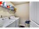 Functional laundry room equipped with modern washer and dryer, and storage shelves at 1709 Creel Ln, Atlanta, GA 30349