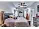 Spacious main bedroom featuring tray ceilings, a ceiling fan, and natural light at 1709 Creel Ln, Atlanta, GA 30349