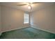 Simple bedroom with green carpet and a ceiling fan above a window at 2410 Deep Shoals Cir, Decatur, GA 30034