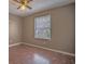 Neutral bedroom with a window looking out to other homes and wood patterned flooring at 2410 Deep Shoals Cir, Decatur, GA 30034