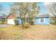 This inviting blue home features a lush front yard with mature trees and plenty of curb appeal at 2410 Deep Shoals Cir, Decatur, GA 30034