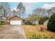Charming brick and siding home with a two-car garage and a well-maintained front lawn at 2410 Deep Shoals Cir, Decatur, GA 30034