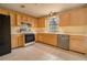 This cozy kitchen has classic cabinets, an oven, a tiled backsplash, and a tile floor at 2410 Deep Shoals Cir, Decatur, GA 30034